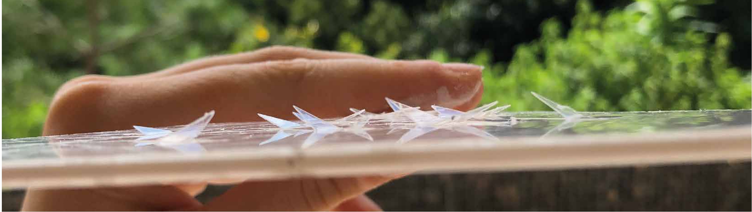 Hand touching fractal acrylic panel — roof detail model